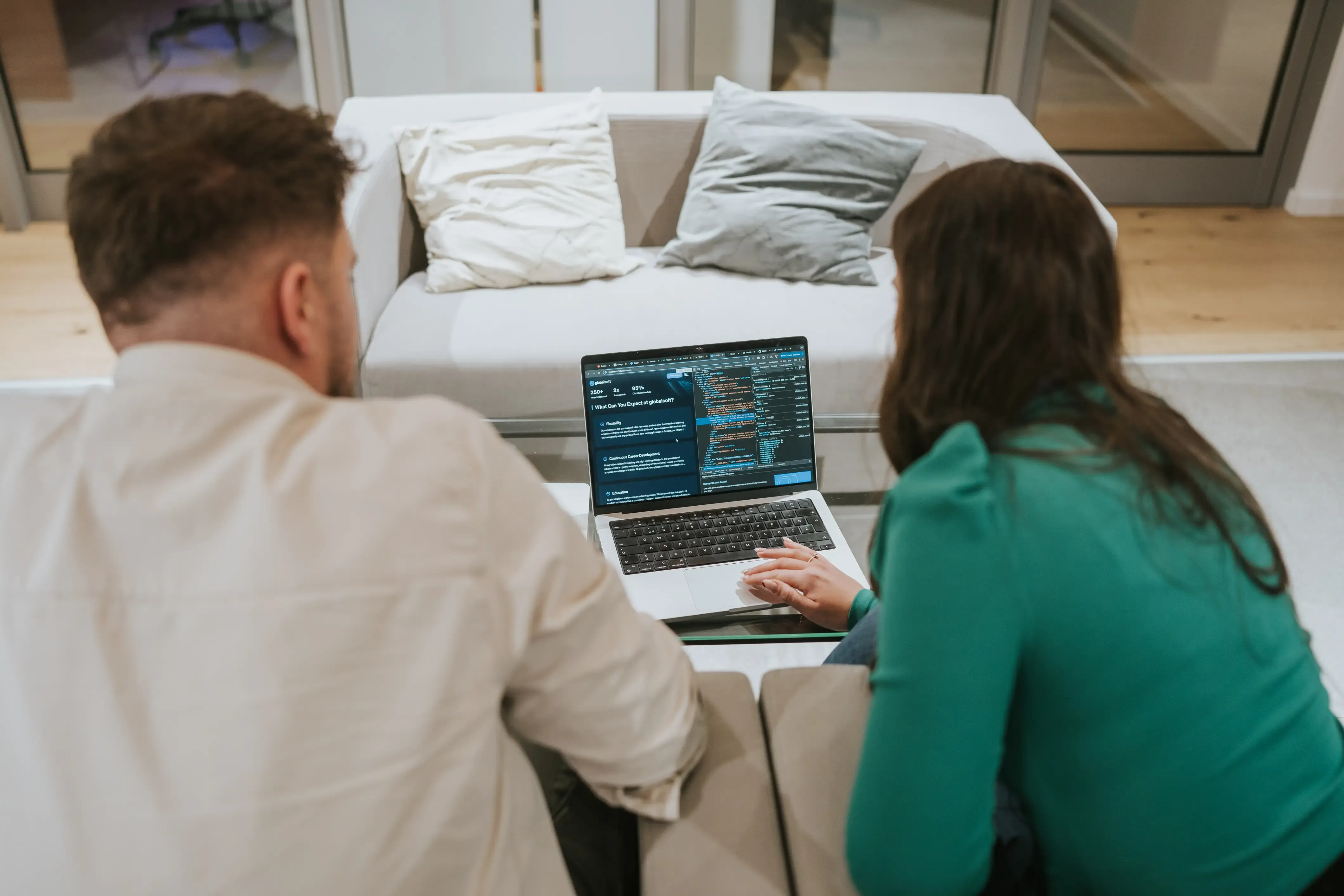 Team members discussing a project with a laptop